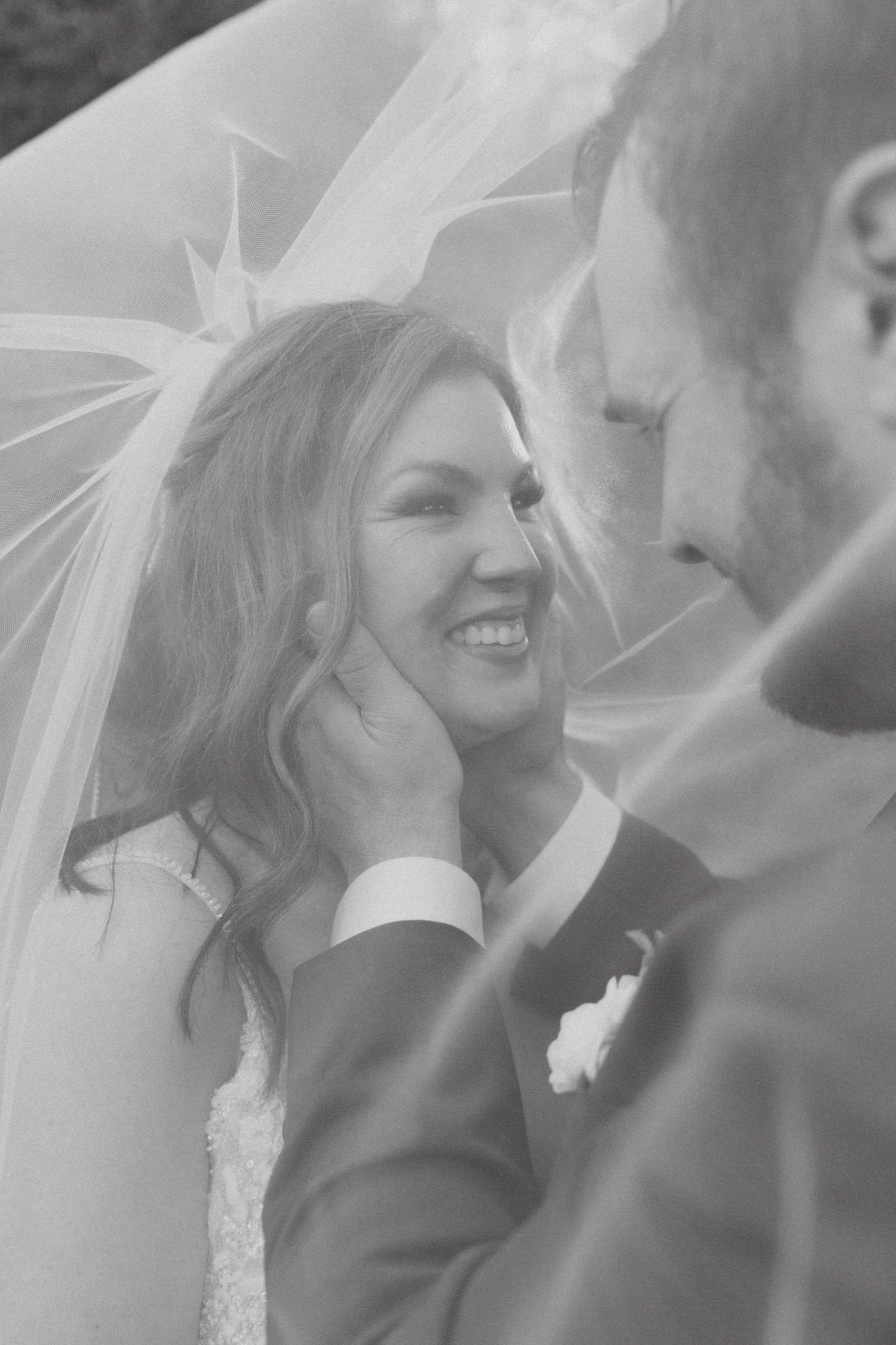 Bride laughing under her veil